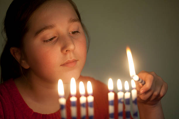istock Girl lights menorah 154885541