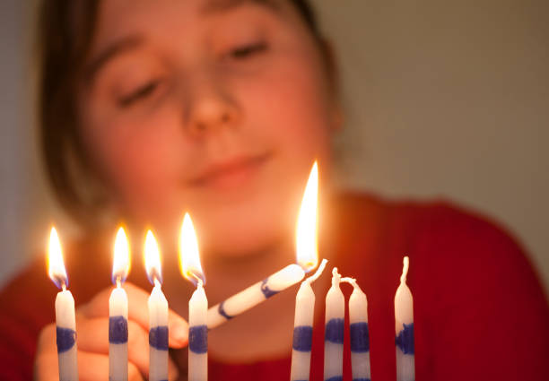 istock Girl lights menorah 154885543