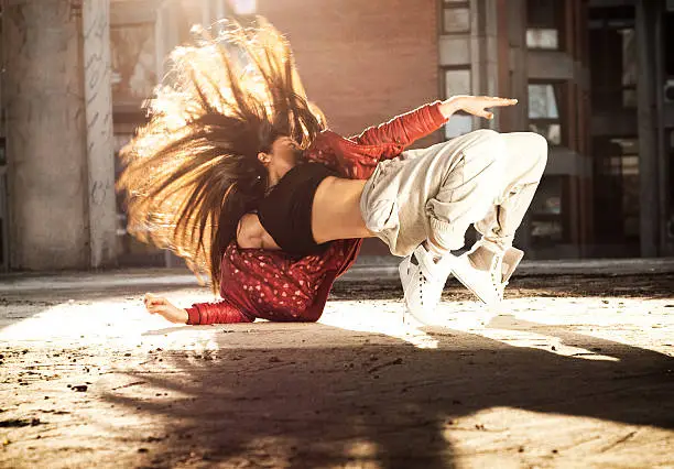 Hip hop dancing woman in urban environment