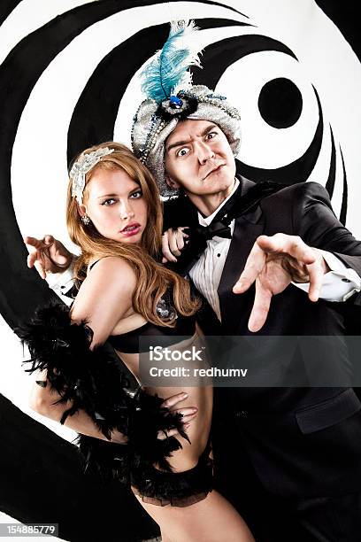 Retro Hypnotist And Beautiful Assistant Stock Photo - Download Image Now - Magician, Hypnosis, Old-fashioned