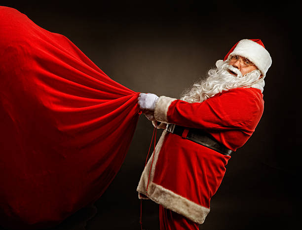 istock Santa Claus holding a BIG gift bag 154887170