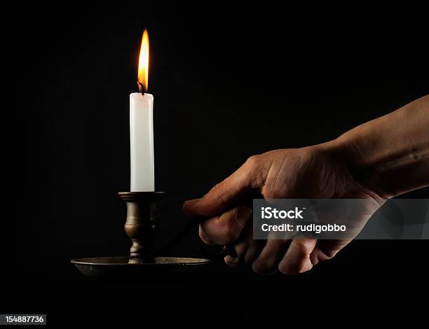 Hand Holding A Lit Candle In The Dark Stock Photo - Download Image Now - Blackout, Candlestick Holder, Candle