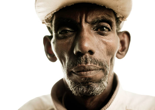 Close up portrait of an aged, grey haired African man, from rural South Africa. Photo has a shallow depth of field.