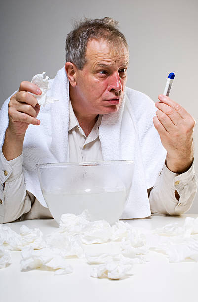 istock Man Suffering From A Cold Shocked At His Body Temperature 154887814