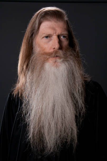 Full face of long bearded man in black robe-isolated