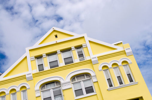 A yellow colored retail  building in Hamilton, Bermuda.