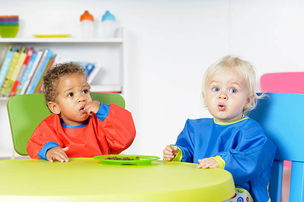 istock Babies/ Toddlers  At Mealtime In A Nursey Setting 154890014