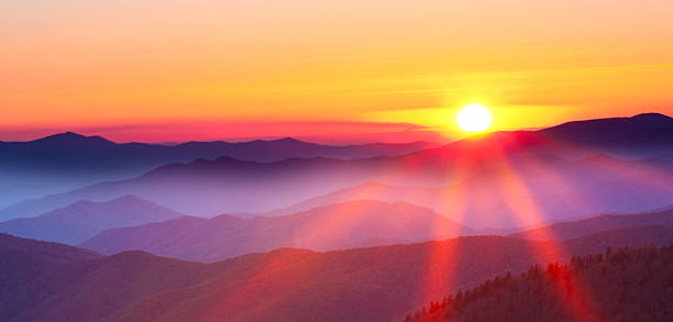 sunset on a foggy mountain range - sunset bildbanksfoton och bilder