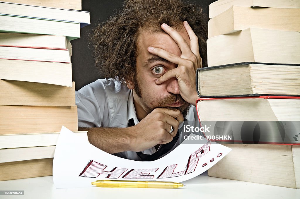 School stress Intellectual Overload, a student among big books. Adult Stock Photo