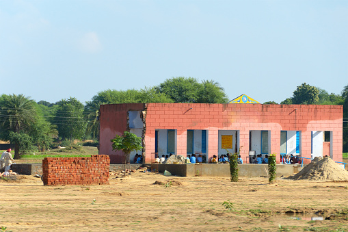 Open air rural Indian school. Ongoing expansion as school is in session. Typical brick construction. Rajasthan, India.
