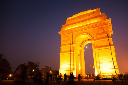 A majestic shot of the India Gate at Night (Kingsway) illuminated at night in New Delhi, India