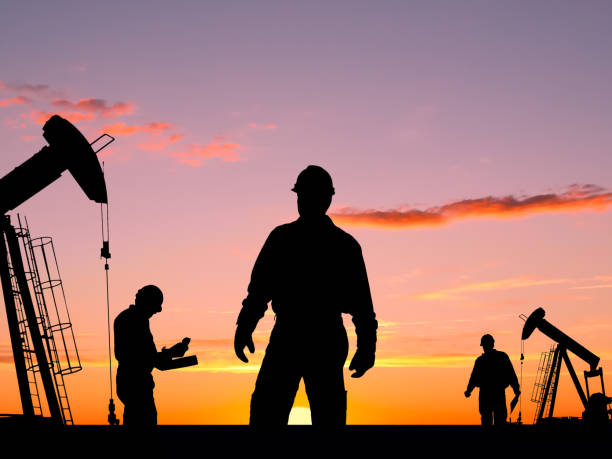 istock Three Workers and Two Oil Pumps At Dawn 154890896