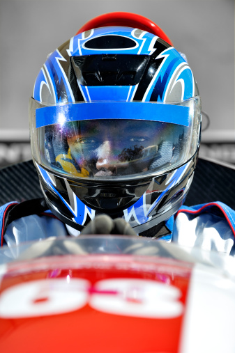 A racing driver concentrating before the start of the race
