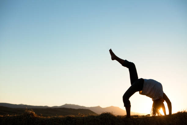 istock Young beautiful woman practicing yoga at sunset 154890920