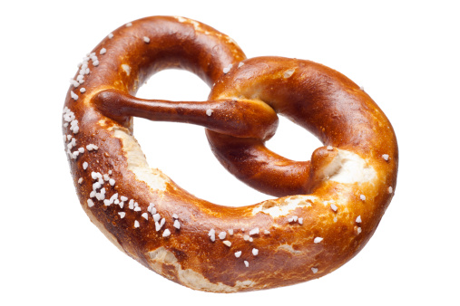 A Bavarian soft pretzel, isolated on white.