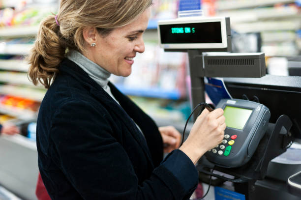 istock Mature woman electronic signing her bill 154891097