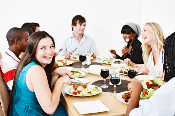 istock Good looking young people enjoying eating together, smiling 154891190