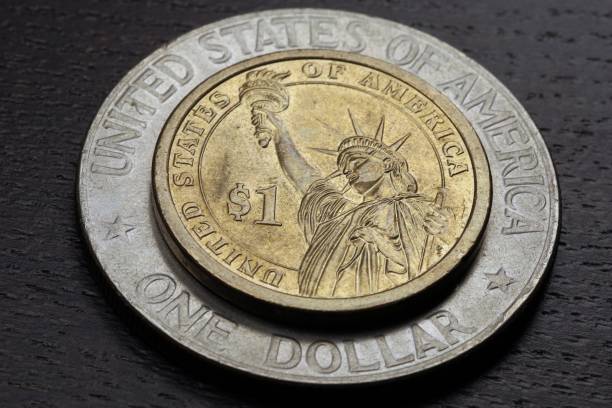 istock Two US One Dollar coins of differnt sizes 1548912287