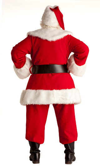 Funny Santa sitting on the ground and looking at camera isolated on white background