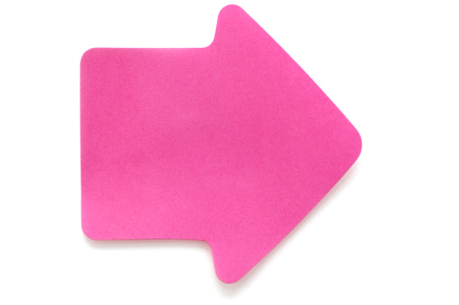 A pink post-it note in the shape of an arrow. Isolated on white.