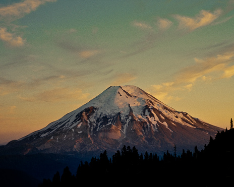On May 18, 1980 Mount Saint Helens violently erupted, and lost much of its upper flanks, shown here covered in snow. This rare picture was taken in 1973. At the time, the mountain was part of the Gifford Pinchot National Forest in Washington State. It has since received recognition as a national monument. This picture has been published many times including its use as the album cover for 