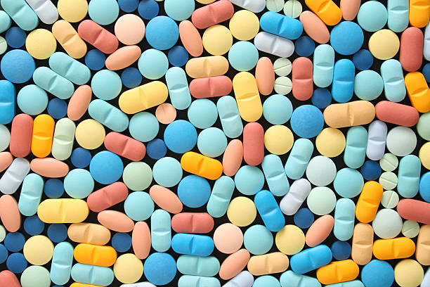 Pills Top view of lots of pills capsule medicine stock pictures, royalty-free photos & images