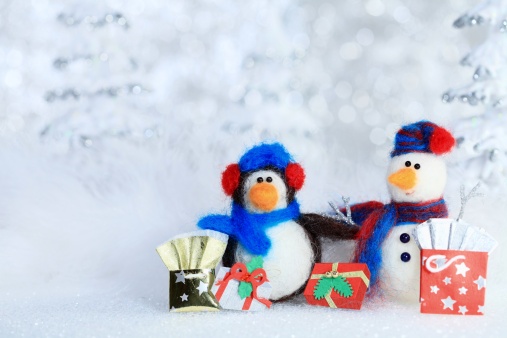 XXXL photo of a penguin and a snowman in a 1970's retro stop motion style with their Christmas shopping gifts and bags in front of a defocused winter forest background.  Selective focus on their eyes and short depth of field so the background is blurred sparkly trees for copy space.  