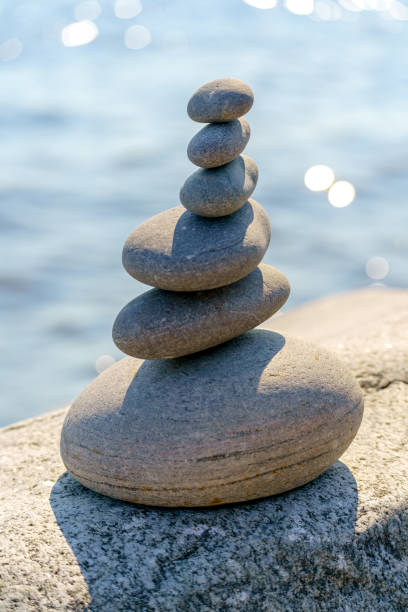 istock Pyramid of stones. Unstable balance of stone objects. 1548927989