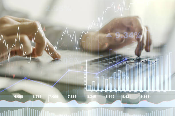 istock Abstract creative financial graph with hand typing on laptop on background, financial and trading concept. Multiexposure 1548931687