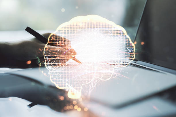 Creative artificial Intelligence concept with human brain sketch and hand writing in diary on background with laptop. Double exposure