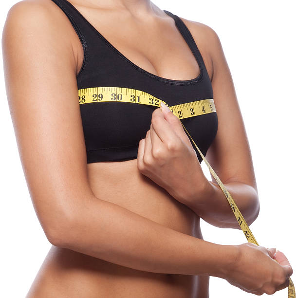 istock Beautiful woman is measuring her breast 154894034
