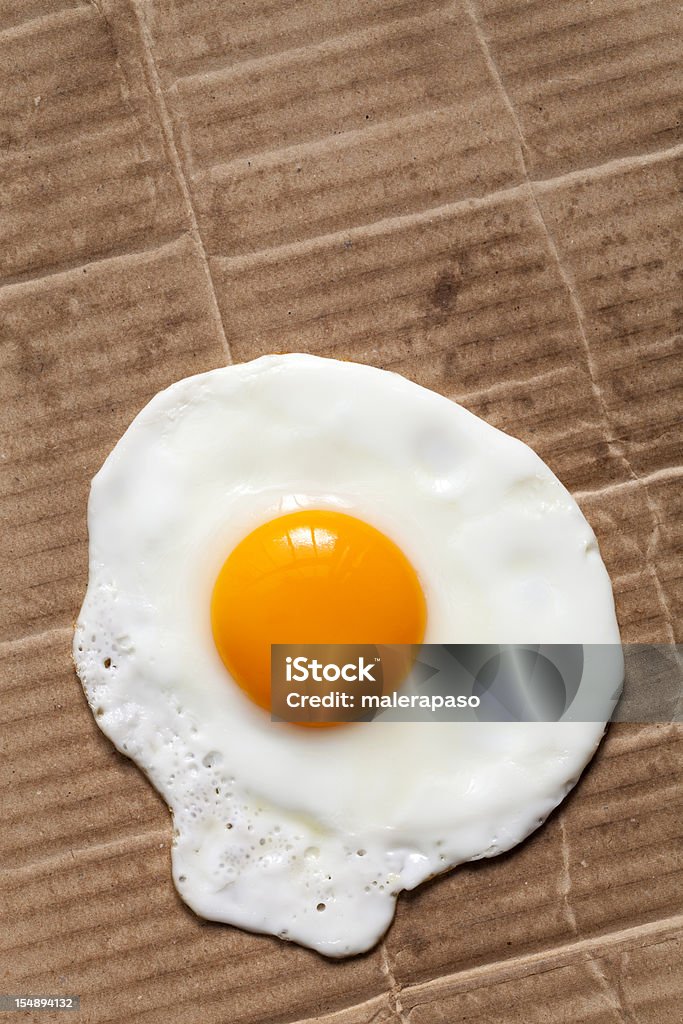 Fried egg on cardboard Fried egg on cardboard.  Fried Egg Stock Photo