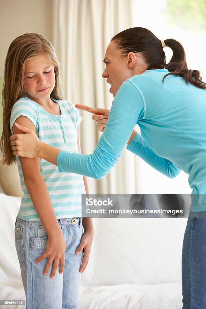Mother Telling Off Daughter At Home Mother Telling Off Young Daughter At Home 10-11 Years Stock Photo
