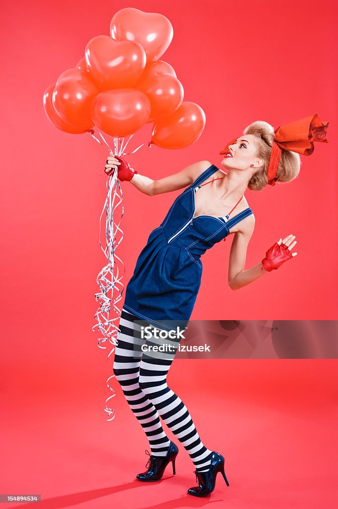 Fashion portrait of woman with red balloons  20-24 Years Stock Photo
