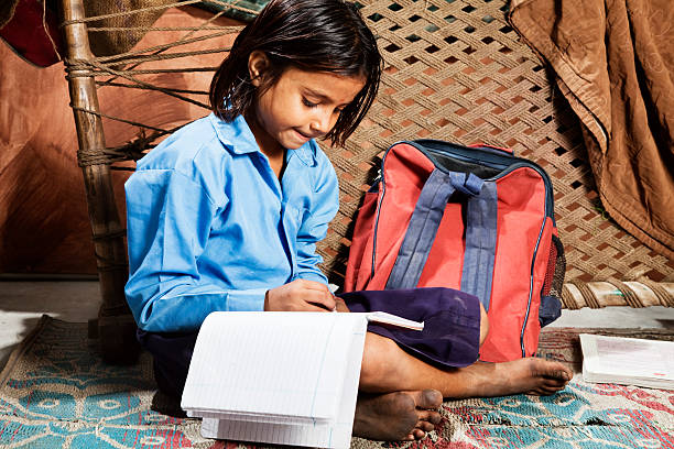 indian girl learning indian schoolgirl doing her homework  at home india poverty stock pictures, royalty-free photos & images