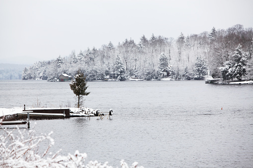 A small evergreen tree stands alone on a tiny, rocky spit of land jutting into a frigid Adirondack State Park region lake. Year-round homes and summer cottages line the forested edge of the lake in the middle distance, with Adirondack Mountain peaks barely visible in the very distant background to the left. Heavy snow is still falling.\n-- -- --\nAdirondack Mountains region:\n[url=file_closeup?id=17933634][img]/file_thumbview/17933634/1[/img][/url] [url=file_closeup?id=17933711][img]/file_thumbview/17933711/1[/img][/url] [url=file_closeup?id=62998775][img]/file_thumbview/62998775/1[/img][/url] [url=file_closeup?id=25727784][img]/file_thumbview/25727784/1[/img][/url] [url=file_closeup?id=25846347][img]/file_thumbview/25846347/1[/img][/url] [url=file_closeup?id=15071022][img]/file_thumbview/15071022/1[/img][/url] [url=file_closeup?id=18691397][img]/file_thumbview/18691397/1[/img][/url] [url=file_closeup?id=87346639][img]/file_thumbview/87346639/1[/img][/url] [url=file_closeup?id=18360142][img]/file_thumbview/18360142/1[/img][/url] [url=file_closeup?id=54913004][img]/file_thumbview/54913004/1[/img][/url] [url=file_closeup?id=44578054][img]/file_thumbview/44578054/1[/img][/url] [url=file_closeup?id=15167415][img]/file_thumbview/15167415/1[/img][/url] [url=file_closeup?id=13879071][img]/file_thumbview/13879071/1[/img][/url] [url=file_closeup?id=15068950][img]/file_thumbview/15068950/1[/img][/url] [url=file_closeup?id=61804144][img]/file_thumbview/61804144/1[/img][/url] [url=file_closeup?id=18693359][img]/file_thumbview/18693359/1[/img][/url] [url=file_closeup?id=50168988][img]/file_thumbview/50168988/1[/img][/url] [url=file_closeup?id=18845078][img]/file_thumbview/18845078/1[/img][/url] [url=file_closeup?id=61804210][img]/file_thumbview/61804210/1[/img][/url] [url=file_closeup?id=54913026][img]/file_thumbview/54913026/1[/img][/url]