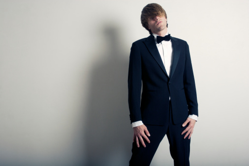 Portrait of a young businessman or groom over blurred background indoors