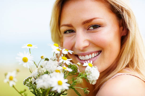 istock An attractive young female with fresh flowers smiling 154894741