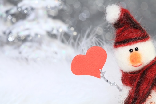 XXXL photo – macro of a cute snowman with a red hat and scarf who is holding a read foam heart.  Short depth of field with focus on his eyes to create the blurry sparkle snowy background.  Snowman made entirely from scratch by the photographer.  very retro 1970’s stop motion animation styled image.