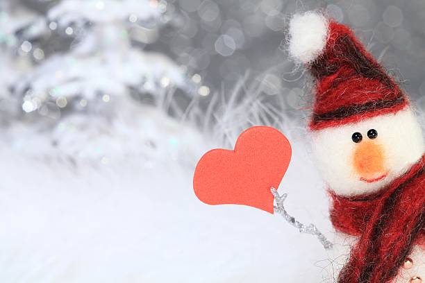 Snowman with red heart stock photo