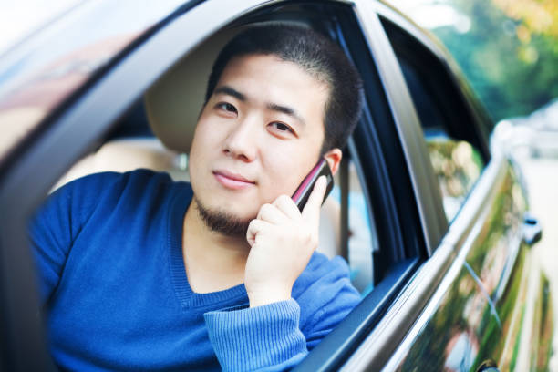Asian man driving car