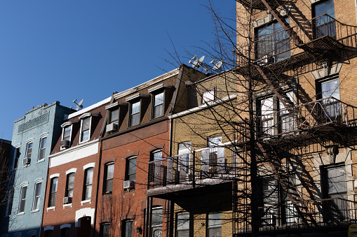 A row of beautiful and colorful old brick homes and residential buildings in Williamsburg Brooklyn of New York City