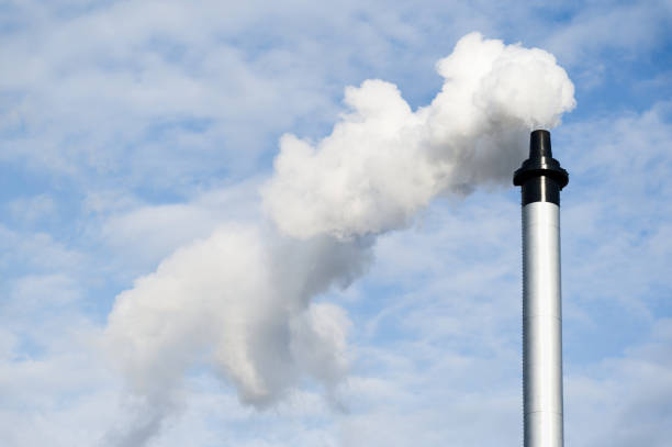 flue chimney and smoke against blue sky - flue gas imagens e fotografias de stock