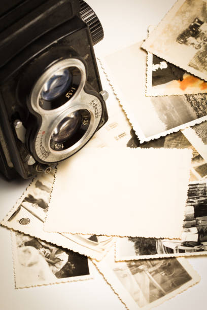 istock Vintage camera with old photos laying in front 154902071