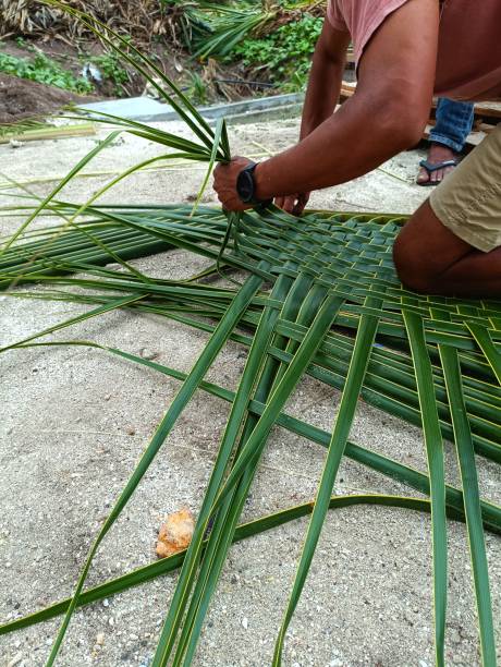 istock A man weaving palm leaf into the mat 1549023865