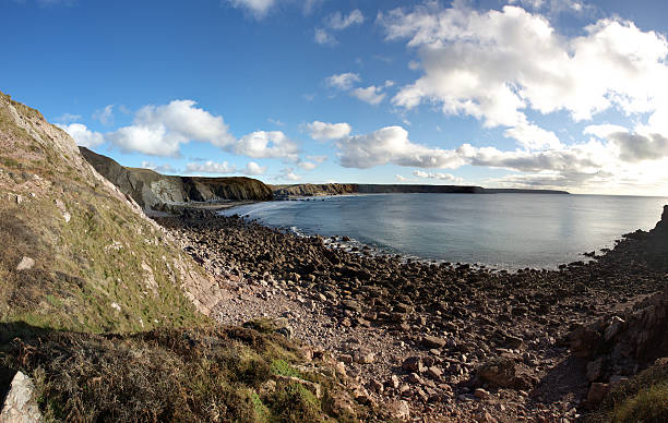 Pebble beach and cliffs at Monkstone Beach near Saundersfoot in Pembrokeshire, Wales, UK