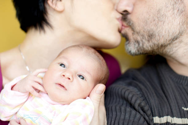 Young couple having a newborn baby girl