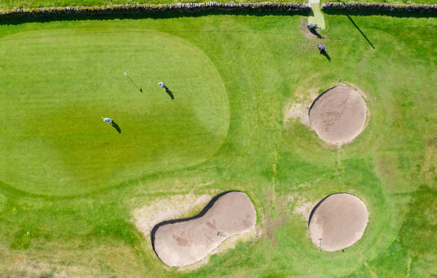 istock Golf course green aerial view and two players 1549035846