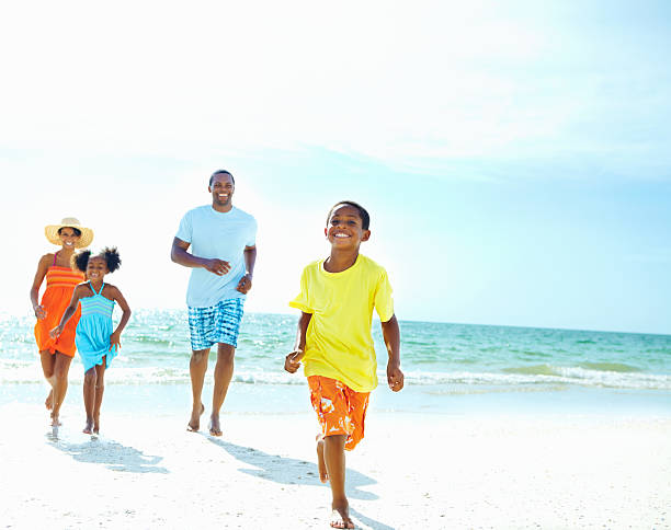 istock Family running on beach away from ocean  154903693