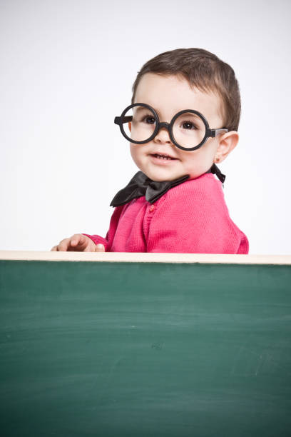 istock Little girl  behind a chalkboard. 154904309